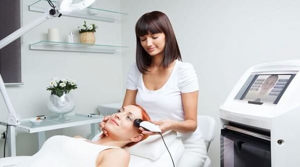 a specialist conducts a skin rejuvenation session with an appliance